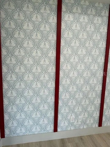 a living room with a fireplace and a wooden floor