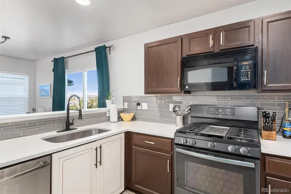 a kitchen with cabinets stainless steel appliances and a sink