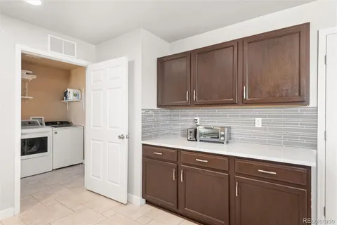 a bathroom with a granite countertop sink and a large mirror