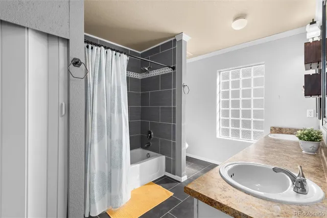 a bathroom with a tub sink and mirror