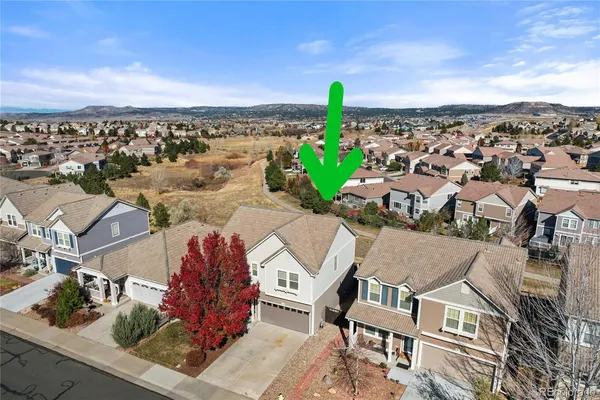an aerial view of multiple houses with a swimming pool