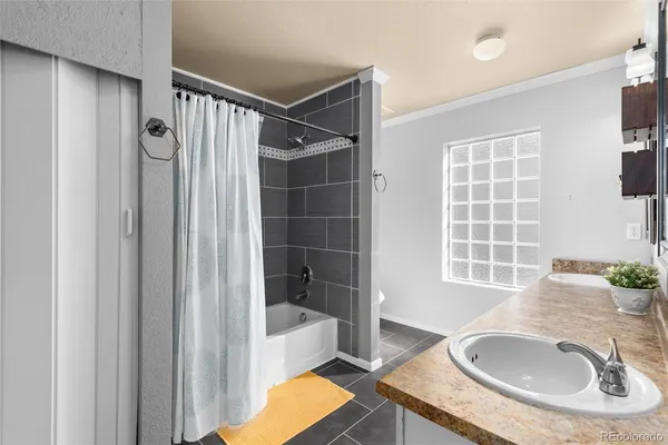 a bathroom with a tub sink and mirror