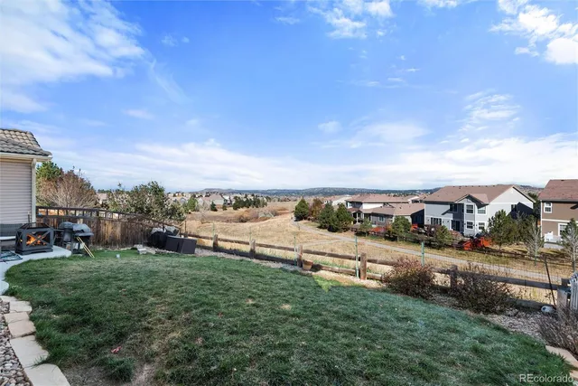 a view of a city street with a yard