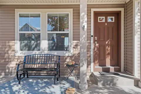 a view of a wooden bench sitting in front of a house