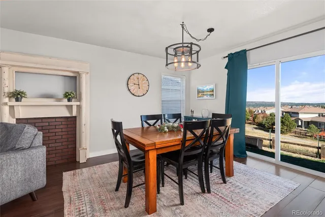 a view of a dining room and livingroom with furniture wooden floor and a rug