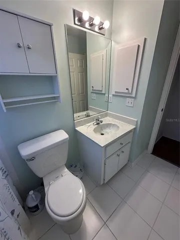 a bathroom with a sink a toilet and mirror