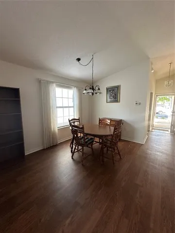 a view of a dining room with furniture and window