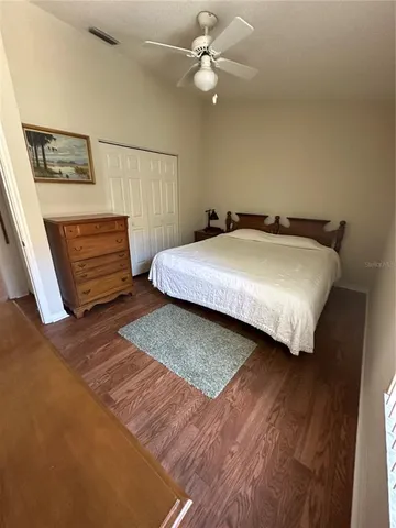 a bedroom with a bed and a ceiling fan