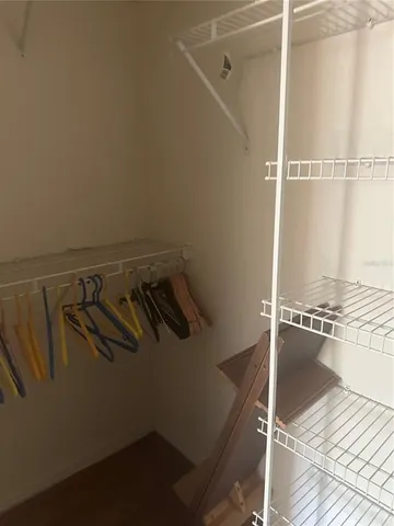 a view of an empty room with a staircase