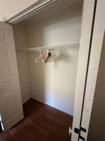 a bedroom with a bed and a mirror