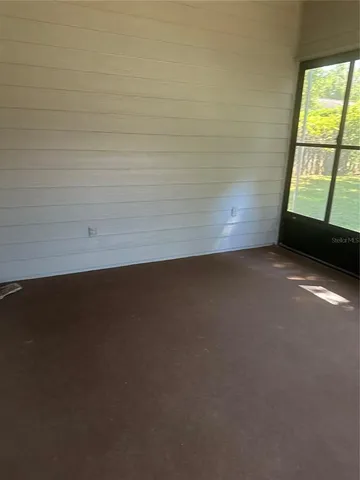 a view of an empty room and a window