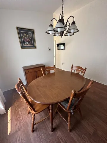 a dining room with furniture and wooden floor