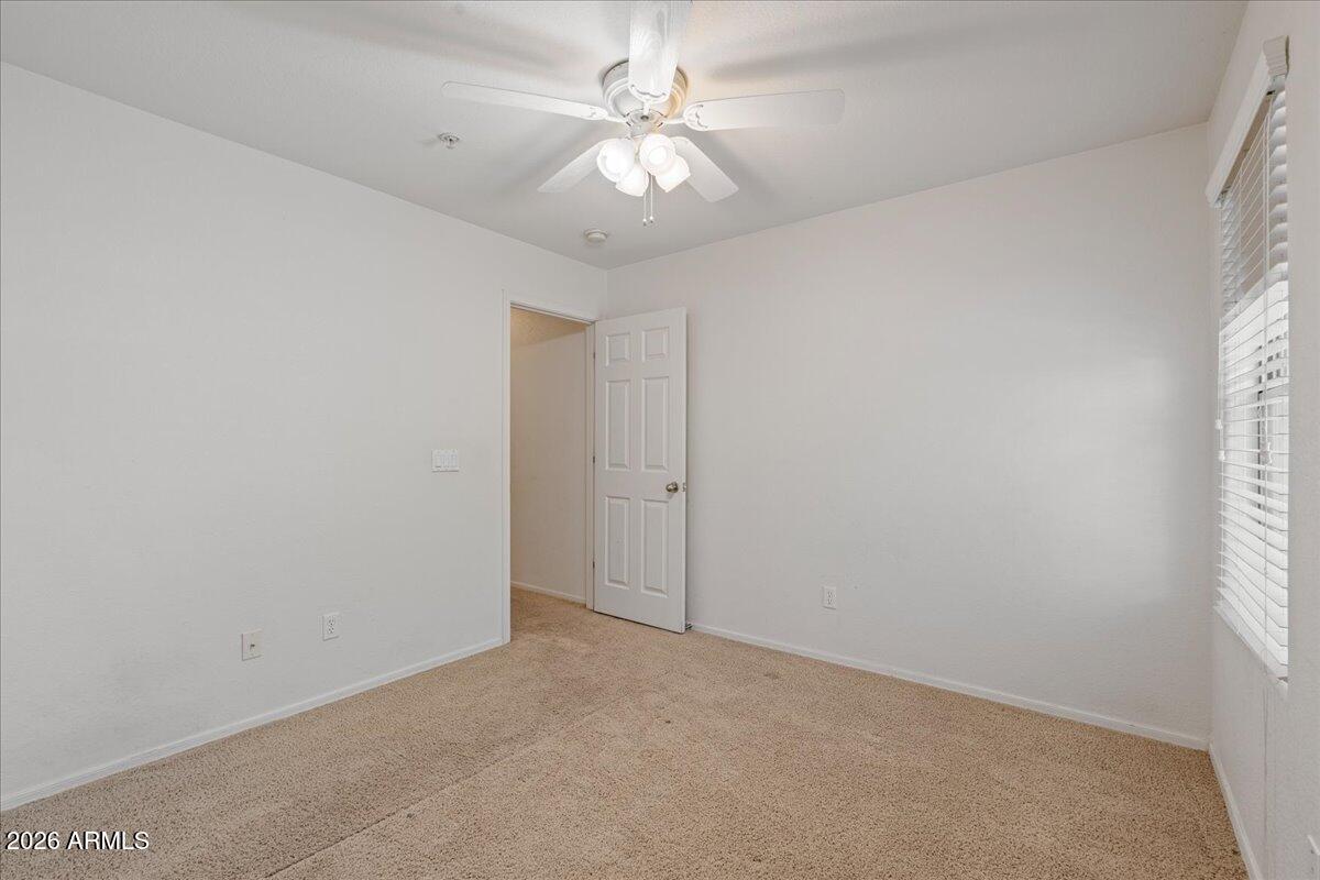 1255 South Rialto, Unit 106 Mesa, AZ 85209 - Photo 19 of 32 an empty room with windows and fan