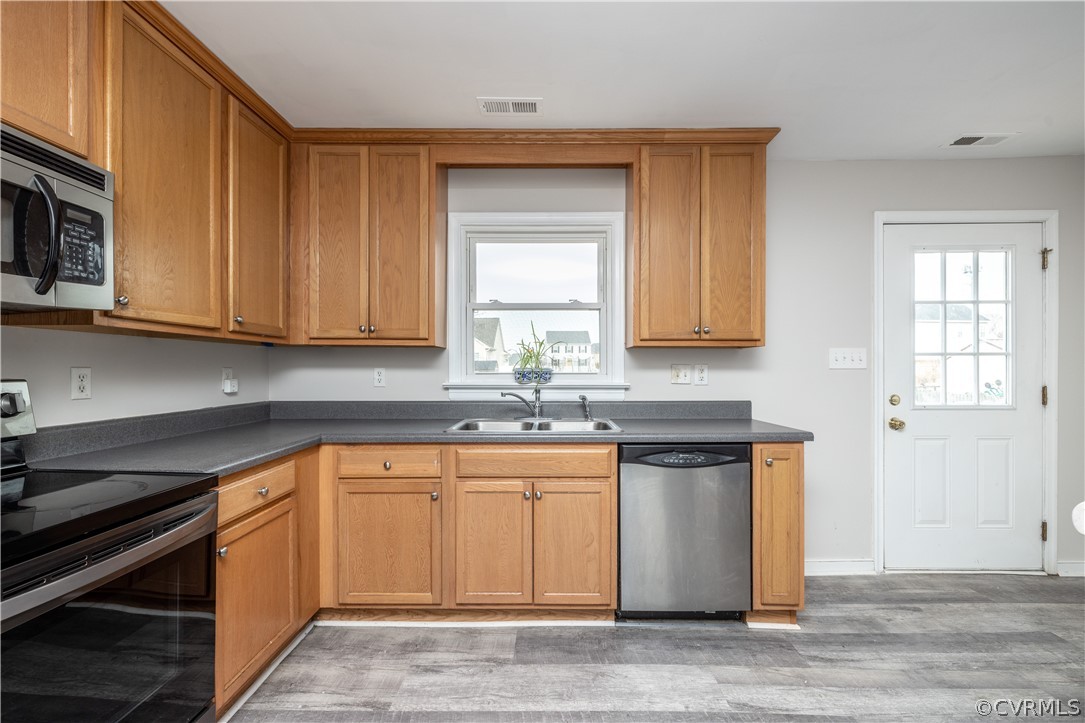 7737 Drexelbrook Road Chesterfield, VA 23832 - Photo 11 of 39 a kitchen with stainless steel appliances granite countertop a sink and a stove top oven
