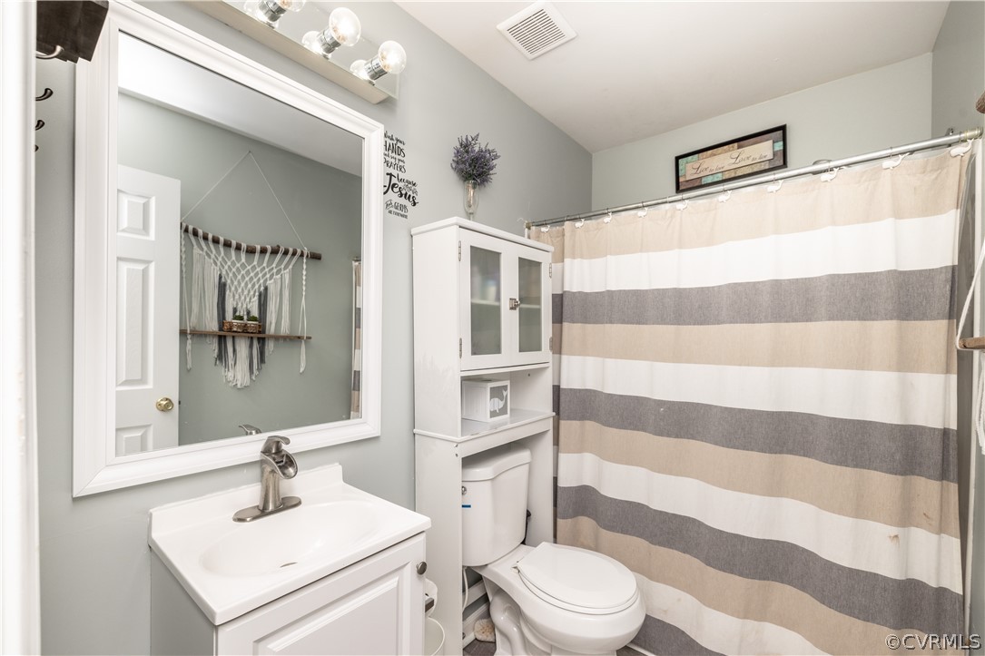 7737 Drexelbrook Road Chesterfield, VA 23832 - Photo 17 of 39 a bathroom with a sink a toilet a shower and a mirror