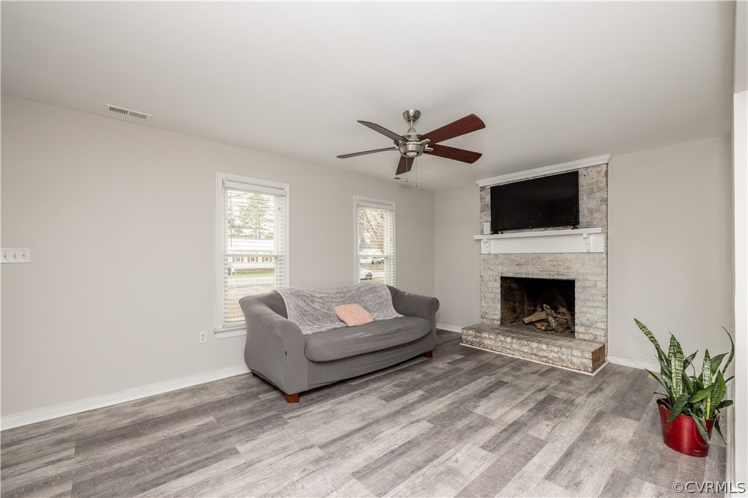 7737 Drexelbrook Road Chesterfield, VA 23832 - Photo 6 of 39 a living room with furniture a fireplace and a flat screen tv