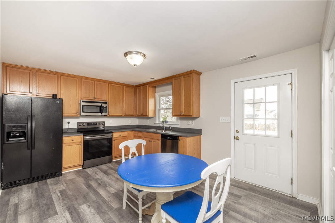7737 Drexelbrook Road Chesterfield, VA 23832 - Photo 9 of 39 a kitchen with stainless steel appliances granite countertop a stove a refrigerator a sink a dining table and chairs
