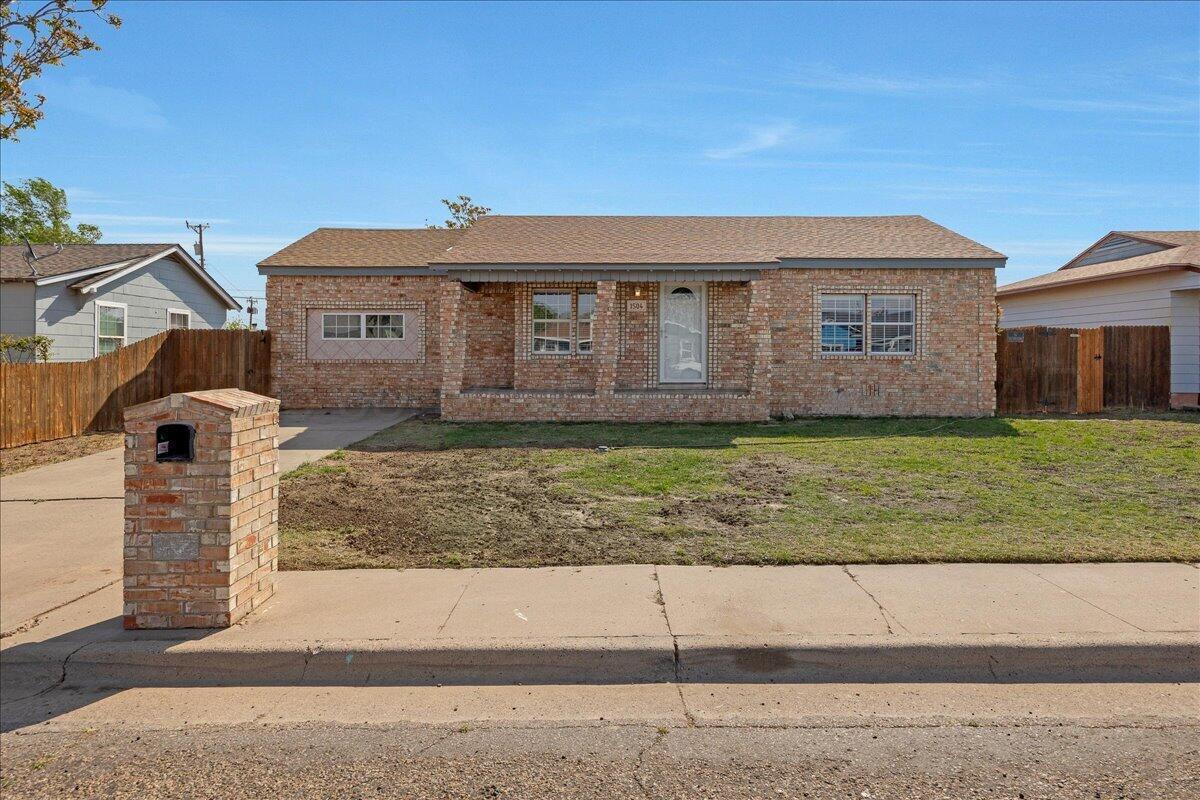 1504 Birch Street Amarillo, TX 79107 - Photo 1 of 19 a front view of a house with a yard