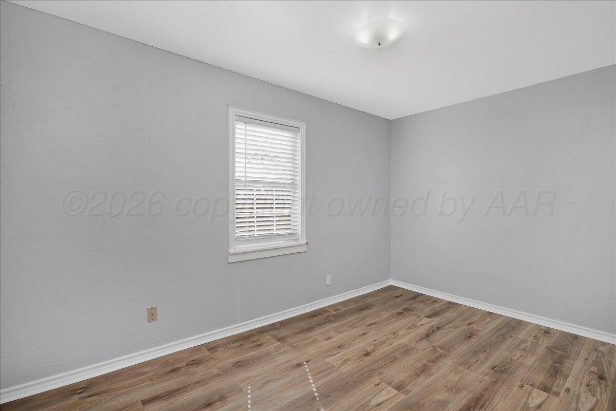 1504 Birch Street Amarillo, TX 79107 - Photo 11 of 19 a view of empty room with wooden floor