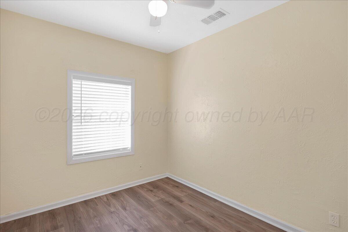 1504 Birch Street Amarillo, TX 79107 - Photo 14 of 19 an empty room with wooden floor and windows