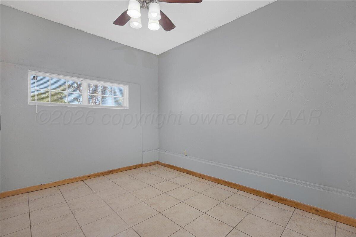 1504 Birch Street Amarillo, TX 79107 - Photo 15 of 19 an empty room with a chandelier fan