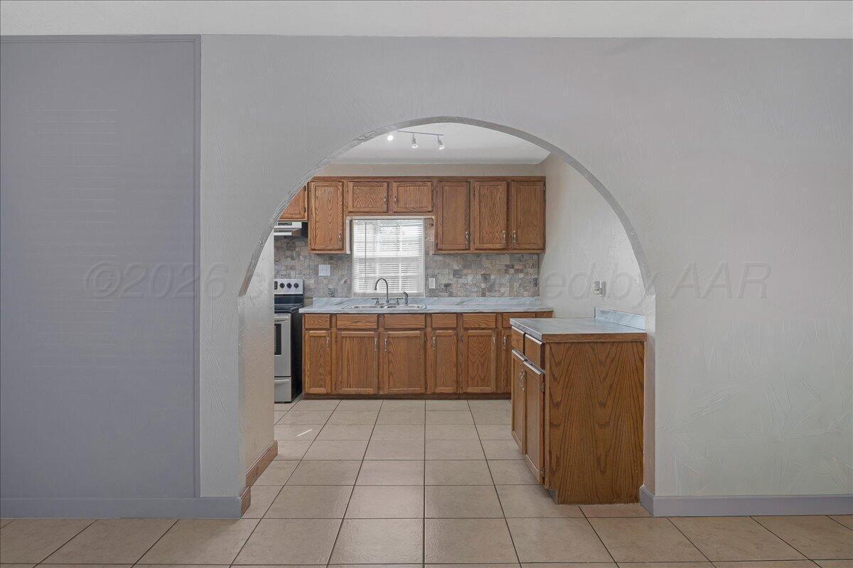 1504 Birch Street Amarillo, TX 79107 - Photo 6 of 19 a kitchen with a sink a counter top space and cabinets