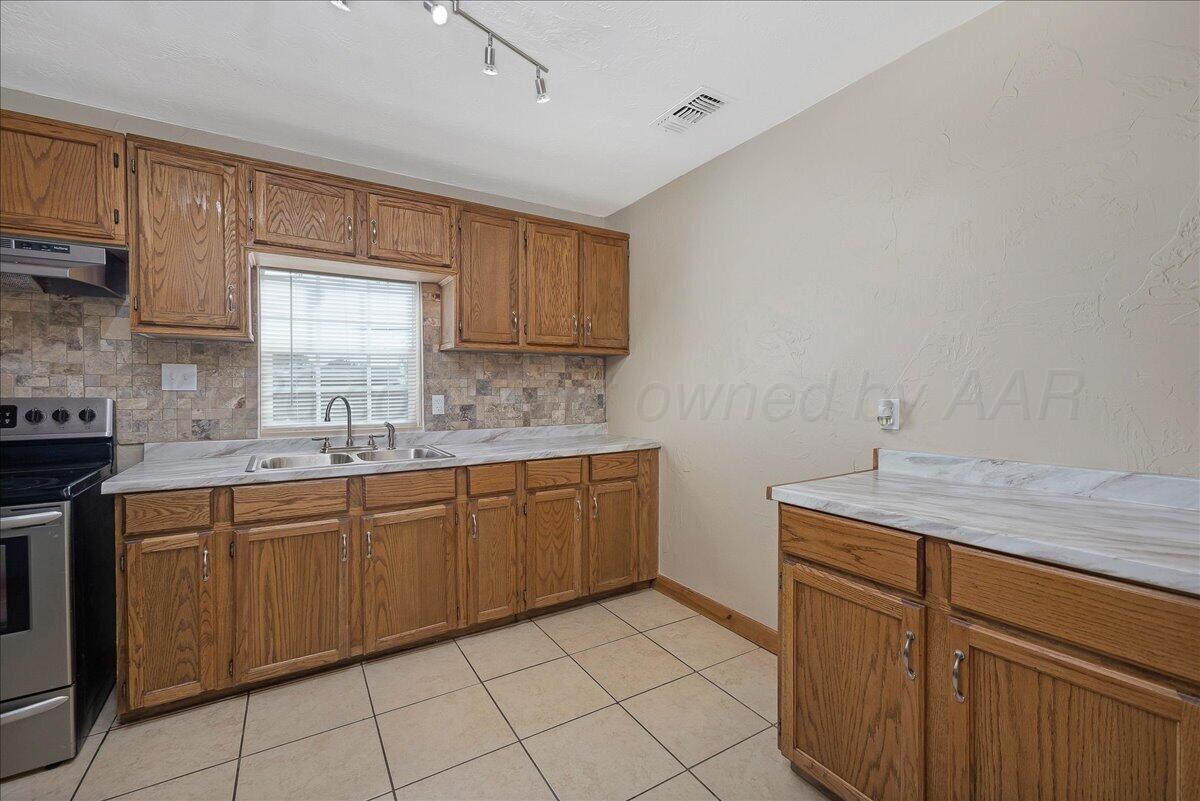 1504 Birch Street Amarillo, TX 79107 - Photo 8 of 19 a kitchen with a sink cabinets and window