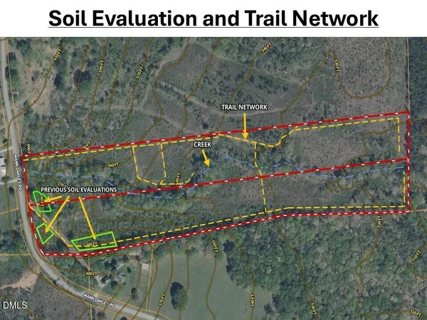 a view of a dry yard with wooden fence