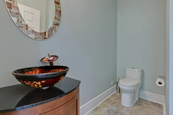 a bathroom with a toilet and a mirror