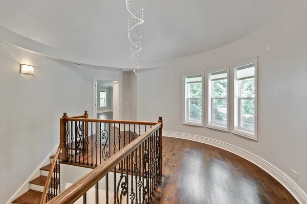a view of room with wooden floor and windows
