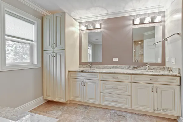 a bathroom with a granite countertop sink a mirror and a window