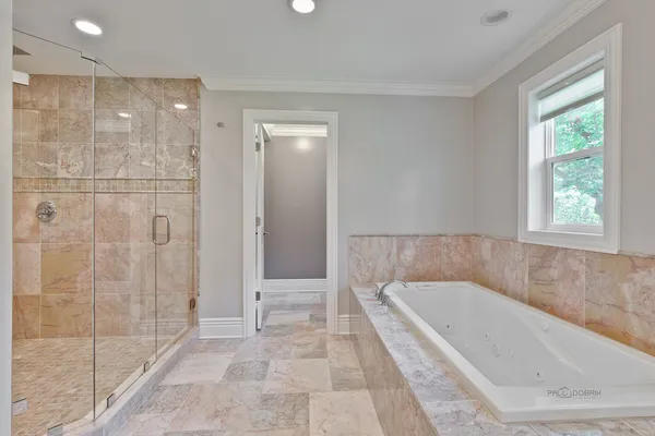 a bathroom with a bathtub and shower