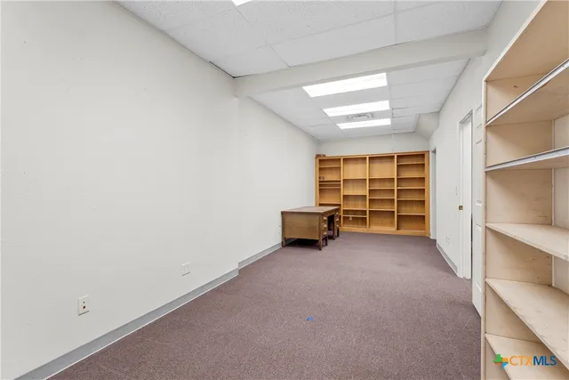 an empty room with furniture and a window