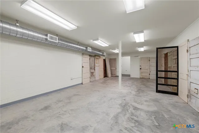 an empty room with closet and mirrors