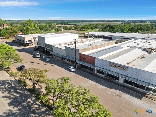 an aerial view of a balcony with chairs