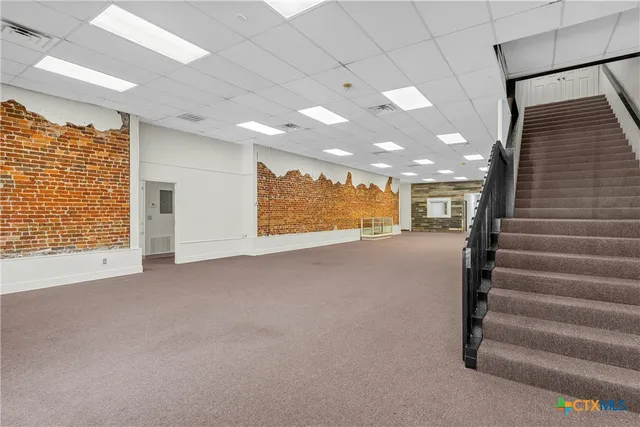 a view of an empty room with stairs