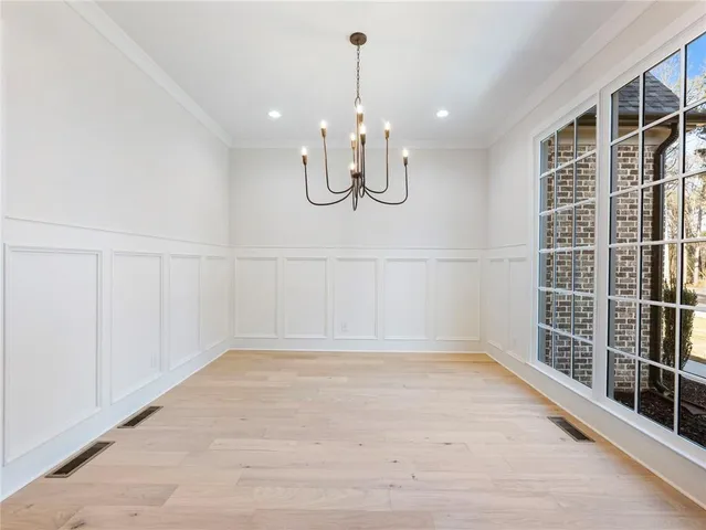 a view of an empty room with a fireplace and a window