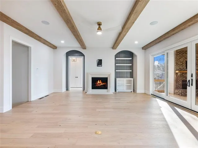 a kitchen with stainless steel appliances granite countertop a sink a stove and a wooden floors