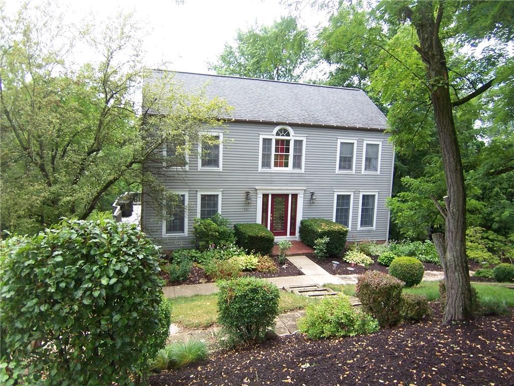Nestled among the trees--you'll fall in love with this charming home.  Leaded entry doors welcome you in!