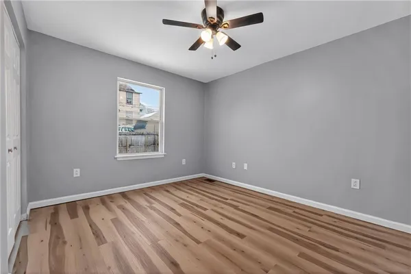 wooden floor in an empty room with a window