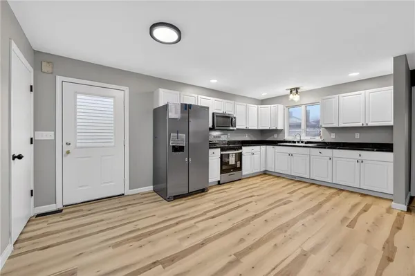 a large kitchen with cabinets and stainless steel appliances
