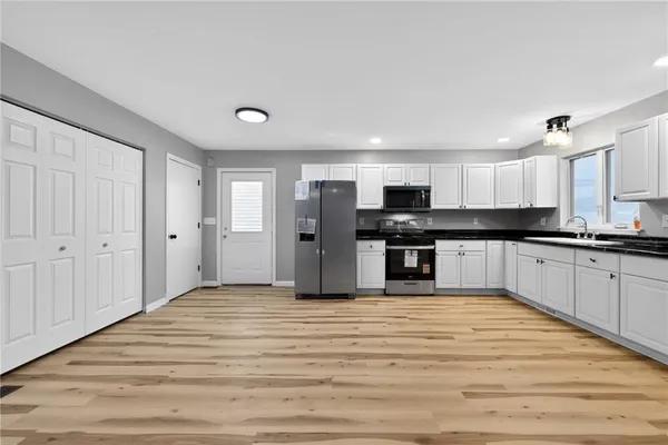 a view of kitchen with wooden floor