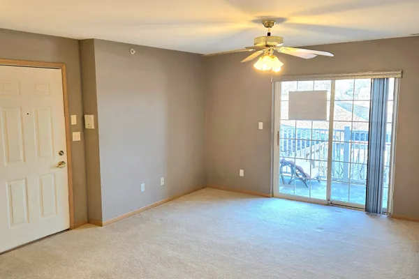 a view of a kitchen with a sink and a refrigerator