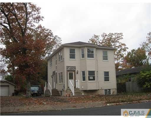 877 Englishtown Road Old Bridge, NJ 08857 - Photo 1 of 8 a view of a white house with a yard