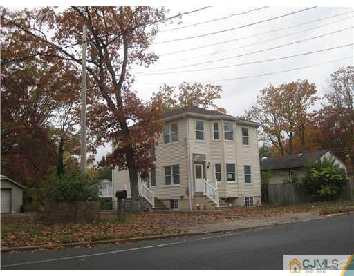 877 Englishtown Road Old Bridge, NJ 08857 - Photo 2 of 8 a view of a white house next to a road