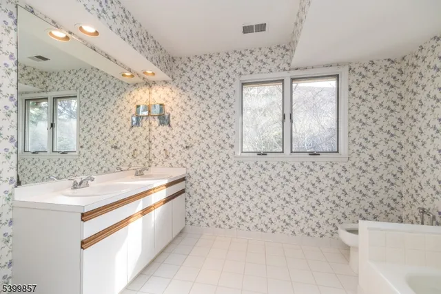 a bathroom with a sink a vanity and a mirror