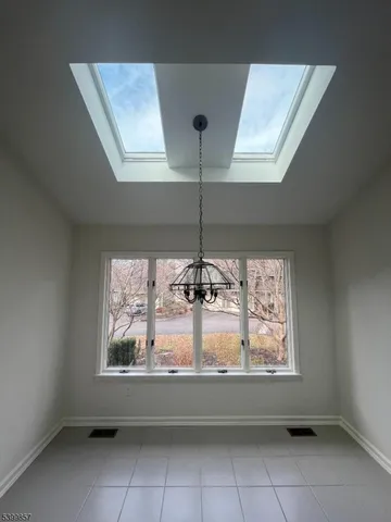 a room with window and chandelier
