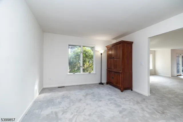 an empty room with a window and a bathroom