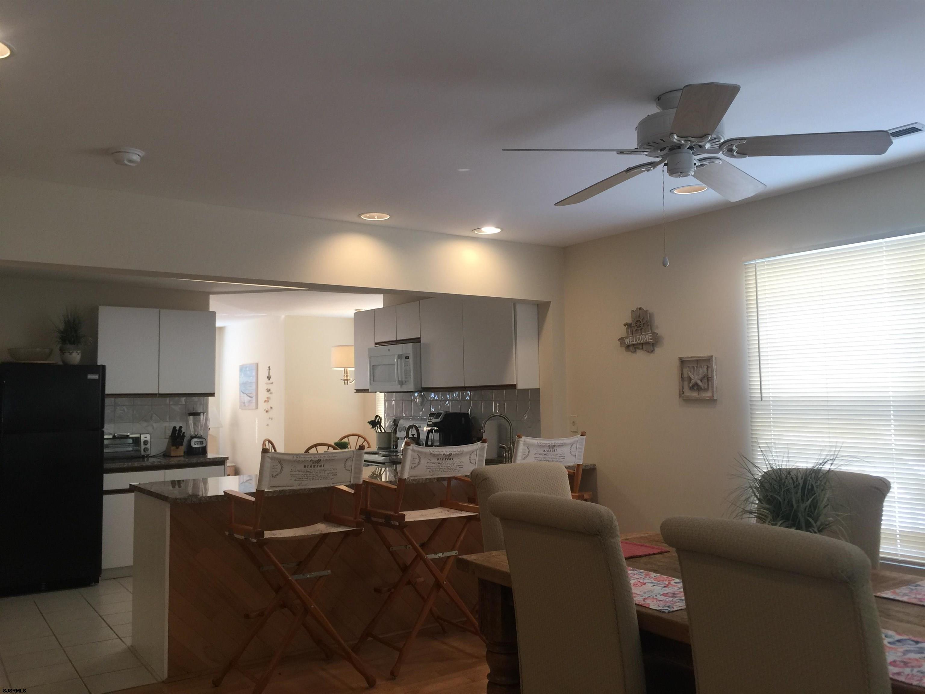 4013 West Brigantine Avenue, Unit 1 Brigantine, NJ 08203 - Photo 14 of 33 a living room with furniture a window and a flat screen tv