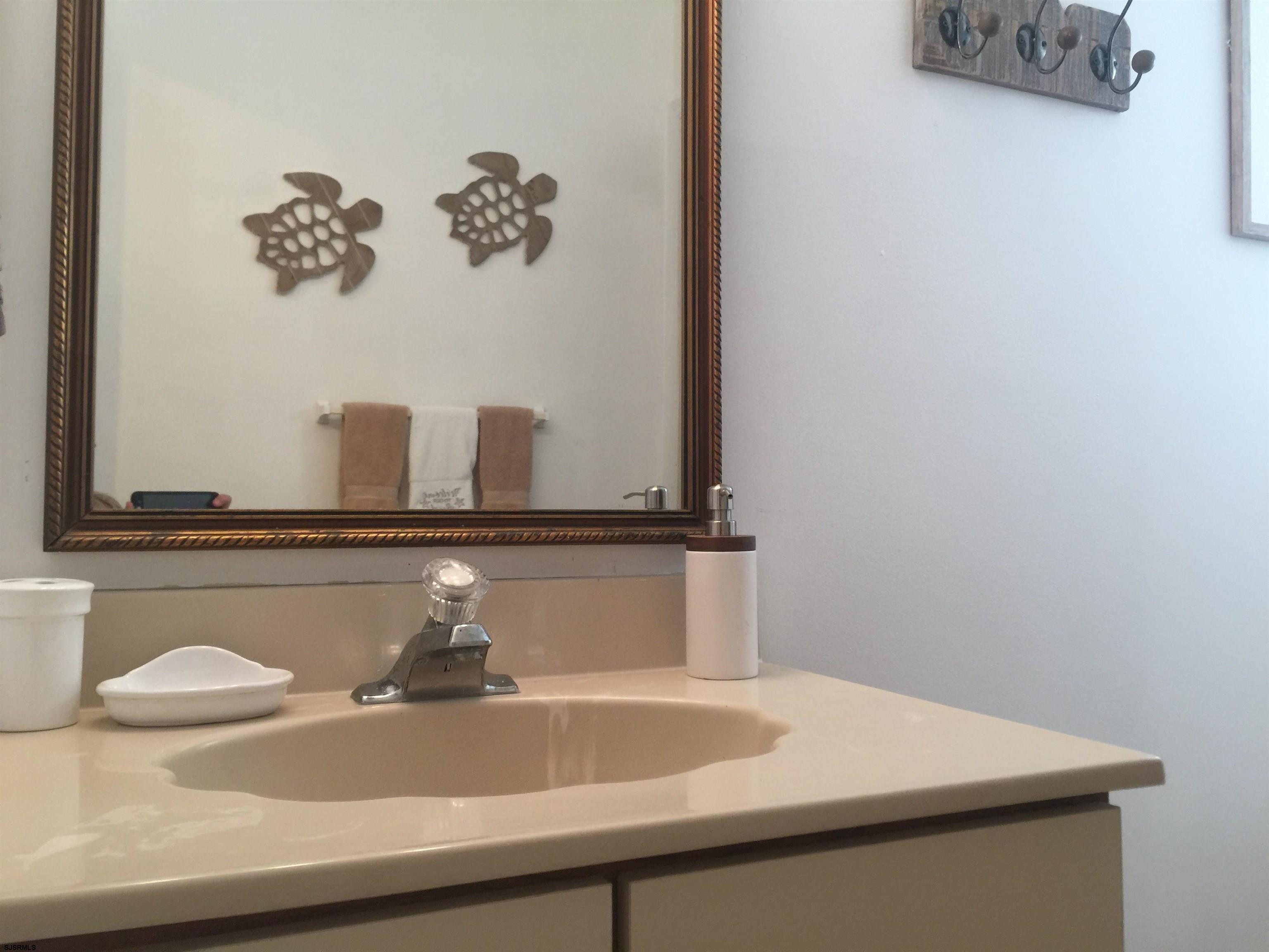 4013 West Brigantine Avenue, Unit 1 Brigantine, NJ 08203 - Photo 16 of 33 a bathroom with a sink and a mirror